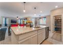 Open-concept kitchen with granite countertops, a view of the pantry, and stainless steel appliances at 3746 Asia Rd, North Las Vegas, NV 89032