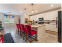 Spacious kitchen island with granite countertops, bright lighting, and modern appliances and white cabinetry at 3746 Asia Rd, North Las Vegas, NV 89032