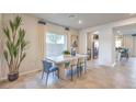Bright dining room features a modern table, stylish chairs, and decorative plants at 4433 Bayley Skye Ave # 104, Las Vegas, NV 89141