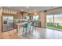 Modern kitchen features stainless steel appliances, an island, and access to the backyard at 4433 Bayley Skye Ave # 104, Las Vegas, NV 89141