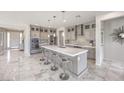 Open concept kitchen with stainless steel appliances, a large island, and a stylish backsplash at 4924 E Cactus Canyon Dr, Pahrump, NV 89061