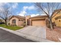 Attractive single-story home boasts a well-maintained lawn, two-car garage, and desert landscaping at 4996 Del Pueblo Ave, Las Vegas, NV 89141
