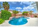 Beautiful backyard pool with lush landscaping, rock accents, and a relaxing spa area at 5024 Granite Creek Ct, Las Vegas, NV 89131