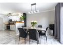 Inviting dining area with modern decor, marble floors, and adjacent kitchen at 509 Chestnut View Pl, Henderson, NV 89052