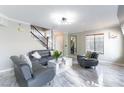 Bright living room showcasing marble floors, modern furniture, and staircase at 509 Chestnut View Pl, Henderson, NV 89052