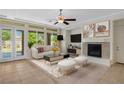 Cozy living room with a fireplace, modern furniture, and large windows, offering a comfortable and inviting space at 5128 Blissful Valley Cir, Las Vegas, NV 89149