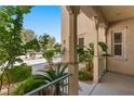 Charming front porch with decorative pillars, lush landscaping, and a cozy seating area, perfect for relaxing outdoors at 5128 Blissful Valley Cir, Las Vegas, NV 89149
