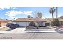 Inviting single-story home with attached garage, manicured front yard and arched entry way at 5175 Palmyra Ave, Las Vegas, NV 89146