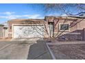 Inviting home features a tidy front yard, two-car garage and cozy entry at 5184 Mineral Lake Dr, Las Vegas, NV 89122