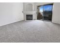 Cozy living room with a decorative fireplace and sliding doors leading to a balcony with a view at 5415 W Harmon Ave # 2048, Las Vegas, NV 89103