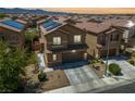 Aerial view of a two-story home, showcasing the neighborhood's layout with solar panels on neighboring roofs at 6409 Dundock Ave, Las Vegas, NV 89122