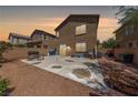 Spacious backyard with gravel landscaping, brick wall, and a concrete patio perfect for outdoor entertaining at 6409 Dundock Ave, Las Vegas, NV 89122