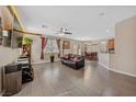 Open-concept living room boasts tile floors, ample natural light, and seamless flow into the dining area at 6409 Dundock Ave, Las Vegas, NV 89122