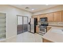 Well-lit kitchen featuring stainless steel appliances and a sliding glass door at 7363 San Pablin St, Las Vegas, NV 89139