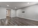 Open floor plan living room featuring wood floors and neutral walls at 7905 Idledale Ct # 102, Las Vegas, NV 89145