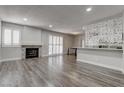 Spacious living room featuring fireplace, wood floors and plantation shutters at 7905 Idledale Ct # 102, Las Vegas, NV 89145