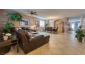 Expansive living room showcasing tile flooring, a cozy seating area, and a formal dining space at 8137 Cape Flattery Ave, Las Vegas, NV 89147