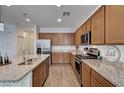 Modern kitchen featuring stainless steel appliances, granite countertops, and custom cabinets at 8164 Golden Cholla Ave, Las Vegas, NV 89179
