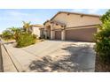Exterior shot of a one story home showing the ample driveway and desert landscaping at 8317 Fritzen Ave, Las Vegas, NV 89131