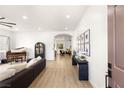 Bright and airy living room with wood floors, piano, and stylish décor at 8317 Fritzen Ave, Las Vegas, NV 89131