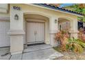 Inviting entryway with double doors, decorative columns, and xeriscaping at 10135 Diving Duck Ave, Las Vegas, NV 89117