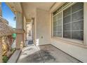 Covered front porch with decorative columns and a smooth concrete walkway at 10135 Diving Duck Ave, Las Vegas, NV 89117
