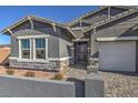 Charming single-story home with paved driveway, stone accents, and a inviting front entrance at 1048 Forrest Falcon Dr, Henderson, NV 89011