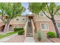 Condo exterior with stairs to the front door, attractive landscaping at 10525 Pine Glen Ave # 206, Las Vegas, NV 89144