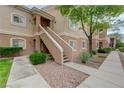 Condo exterior with stairs to the front door, attractive desert landscaping at 10525 Pine Glen Ave # 206, Las Vegas, NV 89144