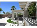 Outdoor patio with bar seating, pergola, and a cozy lounge area, perfect for entertaining at 10591 Haywood Dr, Las Vegas, NV 89135