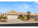 Beautiful single-story home featuring desert landscaping, a tile roof, and a two-car garage at 10712 Back Plains Dr, Las Vegas, NV 89134