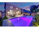 Spacious backyard with a sparkling pool, outdoor seating, and plenty of room for entertaining at 10902 Fintry Hills St, Las Vegas, NV 89141