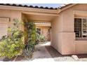 Inviting home entryway with lush greenery, providing a tranquil welcome at 1135 Hidden Mist St, Henderson, NV 89052