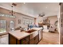 Spacious open-concept kitchen with stainless steel appliances and farmhouse sink at 1135 Hidden Mist St, Henderson, NV 89052