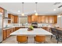 Beautiful kitchen with an island, modern appliances, sleek countertops, and a dining area at 12430 Foxtail Run Ave, Las Vegas, NV 89138