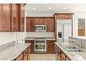 Elegant kitchen featuring granite countertops, stainless steel appliances, and custom cabinetry at 1252 Casa Palermo Cir, Henderson, NV 89011