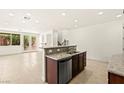 Bright, open floor plan showcasing the kitchen island and stainless steel dishwasher at 1252 Casa Palermo Cir, Henderson, NV 89011