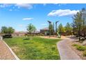 Community park offers a playground, lush grass, and a walking path for neighborhood enjoyment at 133 Clouded Ave, Henderson, NV 89002