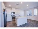 New kitchen with stainless steel appliances, white cabinets and a large island with a sink at 145 Aqua Commons Ln, Henderson, NV 89015