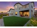 Charming home features a lush backyard lawn and a covered patio area, perfect for outdoor entertaining at 2004 Peaceful Mesa Ct, Henderson, NV 89052