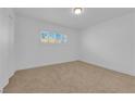 Bright bedroom with window shutter offers neutral carpet, white walls, and ample natural light at 2058 Citroen St, Las Vegas, NV 89142
