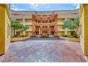 Gorgeous courtyard featuring symmetrical landscaping, mature trees and fountain at 210 E Flamingo Rd # 215, Las Vegas, NV 89169
