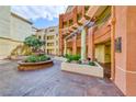 Inviting courtyard featuring a decorative fountain, seating and mature landscaping at 210 E Flamingo Rd # 215, Las Vegas, NV 89169