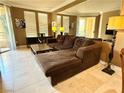 Comfortable living room featuring a large sectional couch, stylish decor, and access to an outdoor balcony at 210 E Flamingo Rd # 215, Las Vegas, NV 89169