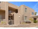 Exterior view of tan stucco condos with railings, desert landscaping, and covered parking at 2200 Highpointe Dr # 202, Laughlin, NV 89029