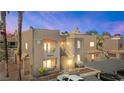 A tan stucco condo building has an attached covered parking area and desert landscaping at 2200 Highpointe Dr # 202, Laughlin, NV 89029