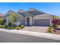 Beautiful single story home with lush landscaping and a three car garage at 2433 Cingoli St, Henderson, NV 89044