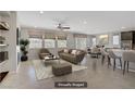 Open concept living room is virtually staged with modern furnishings and neutral colors at 2433 Cingoli St, Henderson, NV 89044