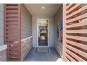 Inviting entryway with textured walls, wood slats, and stylish decor, offering a glimpse into the home's open layout at 2489 Cingoli St, Henderson, NV 89044