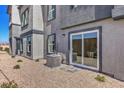 Gray home exterior featuring a gravel area and direct access to the home via sliding glass doors at 2534 Petunia Garden St # 222, North Las Vegas, NV 89081